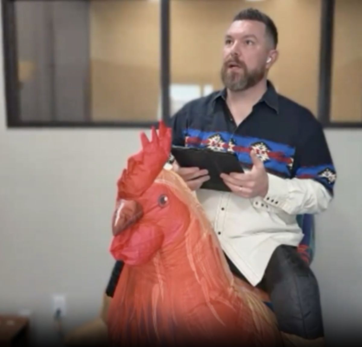 Tyler riding an inflatable rooster